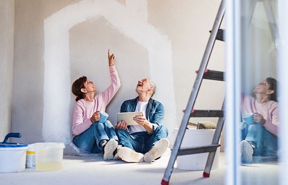 Couple looking at an iPad painting