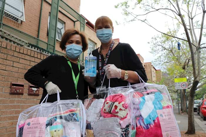 Two ladies holding bags